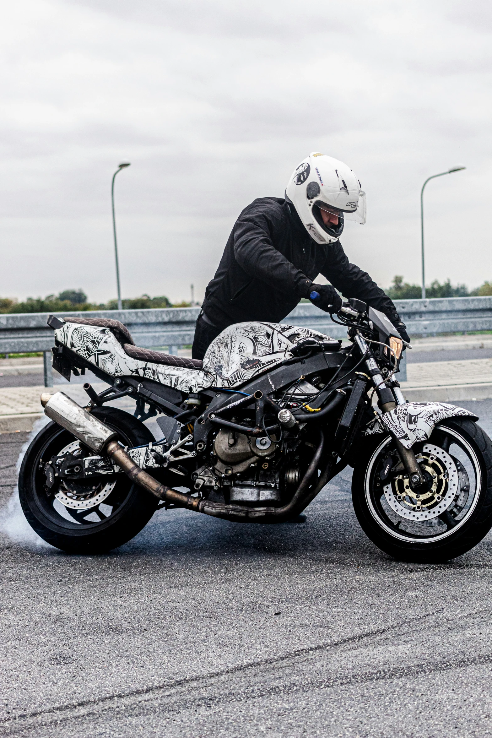 a man rides his motorcycle on an empty road