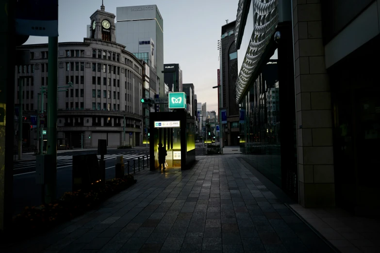 street scene in dark and dim with the green light