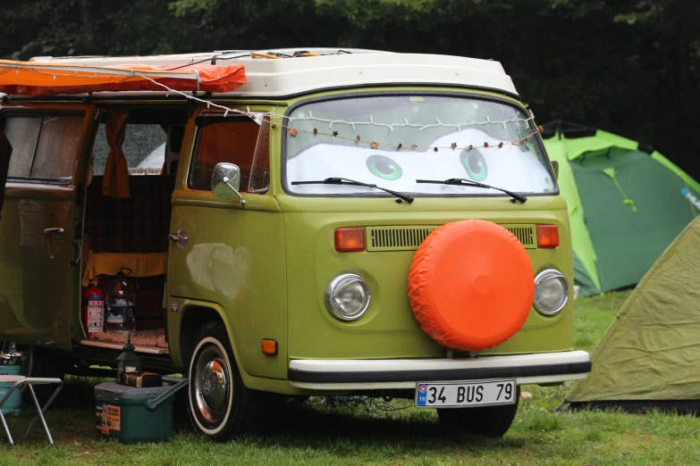 an old vw camper has its back turned and the front end is up