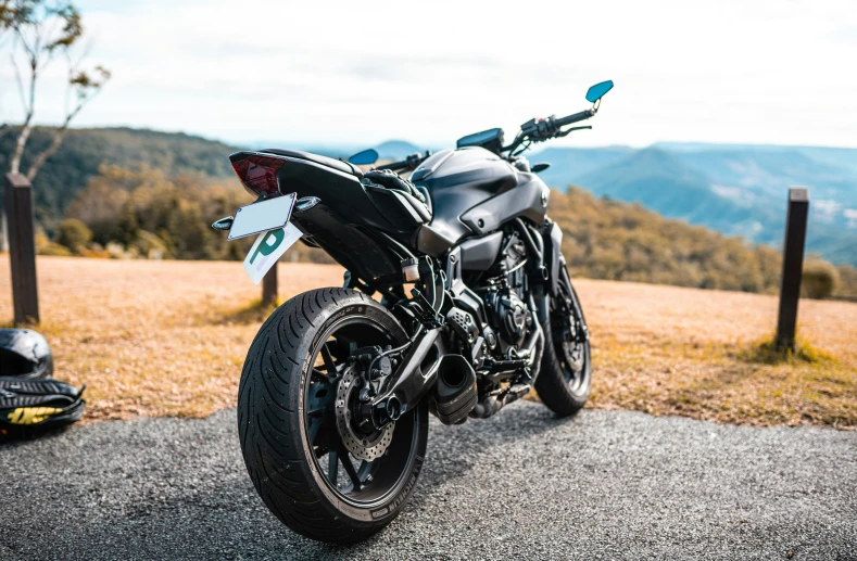 a motorcycle parked next to the top of a hill