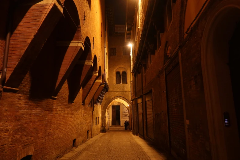 an empty tunnel leads through a brick building