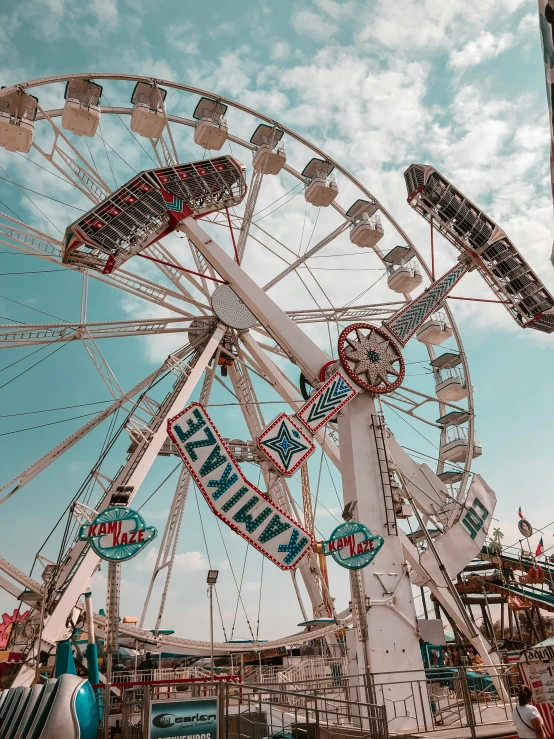 the ferris wheel has several signs attached to it