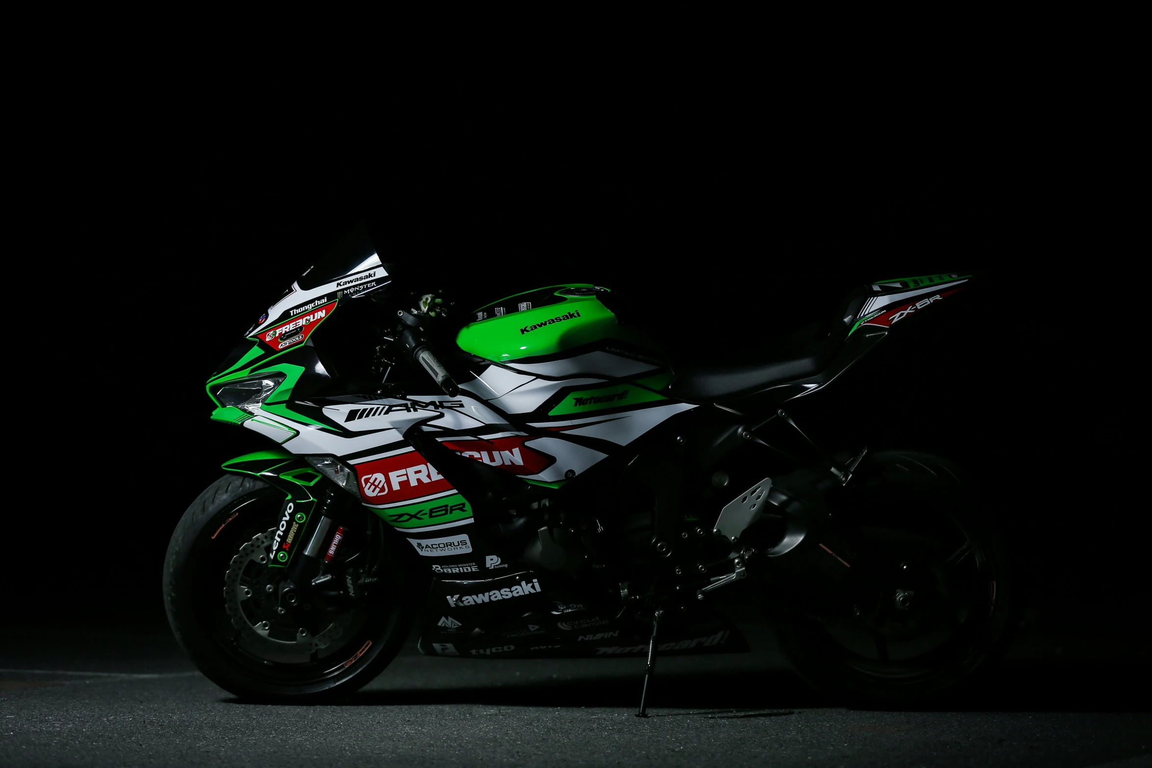 the motorcycle is black and has green stripes