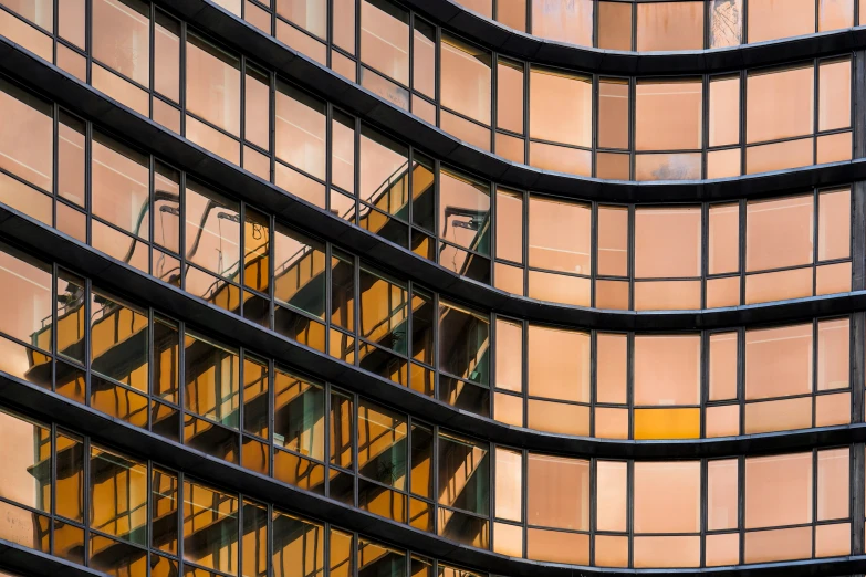 the reflection of the sky on the glass windows of a skyscr building