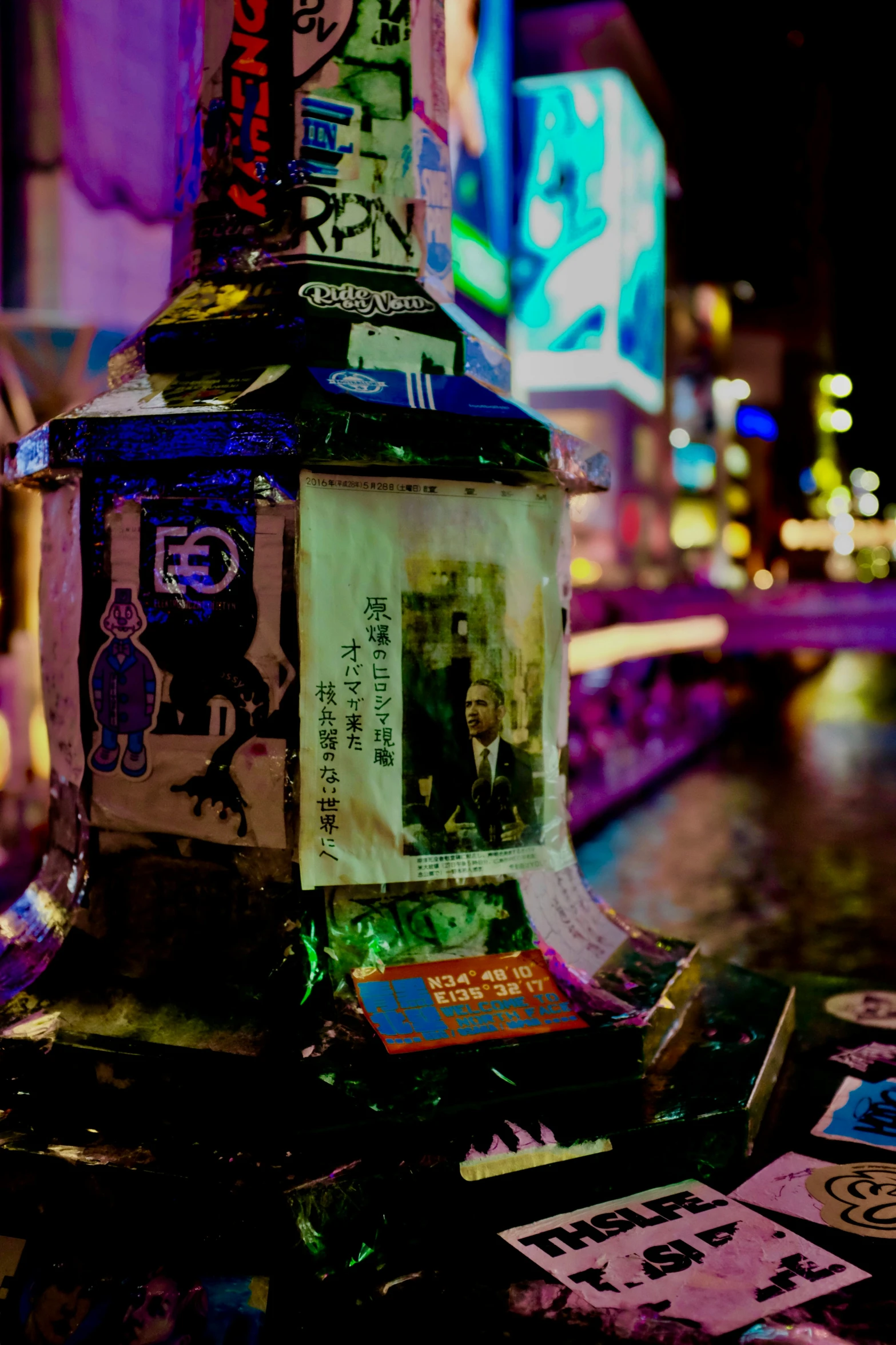 a lamp post lit up with stickers on it