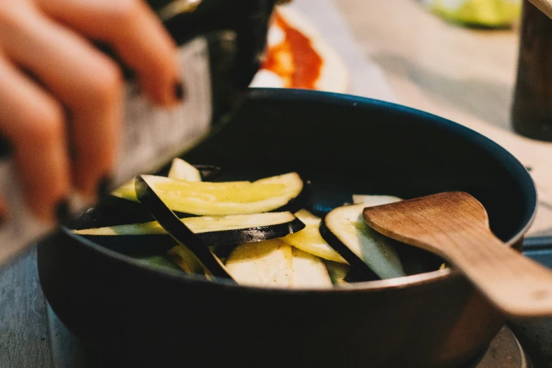 a person stirring food in a set