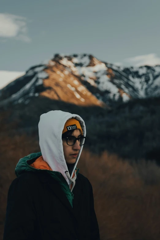 a man standing in front of a mountain