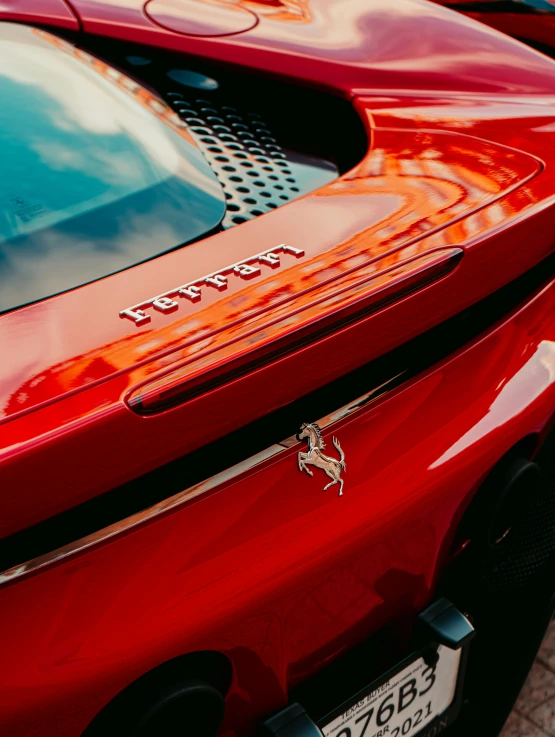 a red sports car parked next to another car