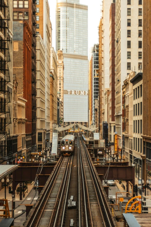 a subway runs through the city with a view of skyscrs