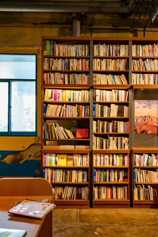 a bookshelf filled with lots of different colored books