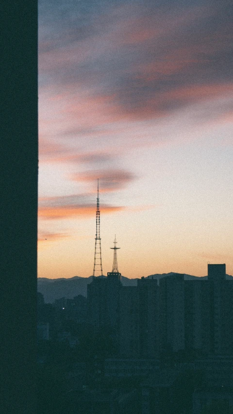 a view of the clouds at dusk from a rooftop