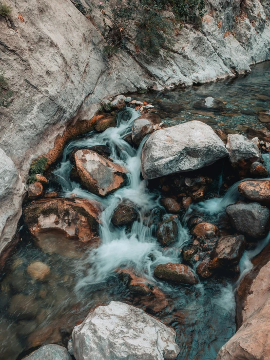 a river that is going through some rocks