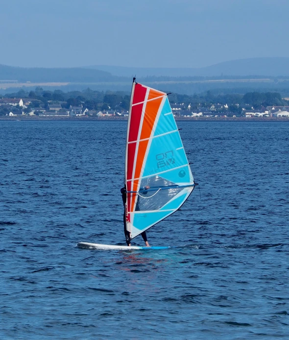 a man on a sailboat in the water