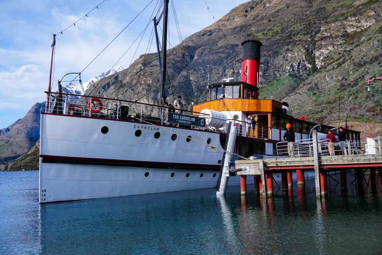 a very pretty large boat docked at the dock