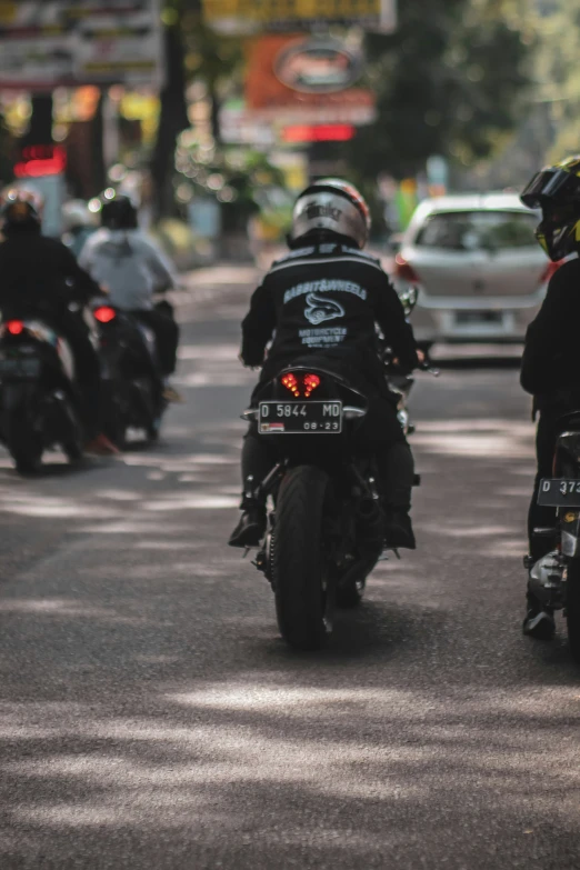 two motorcyclists on the road with their motorcycles