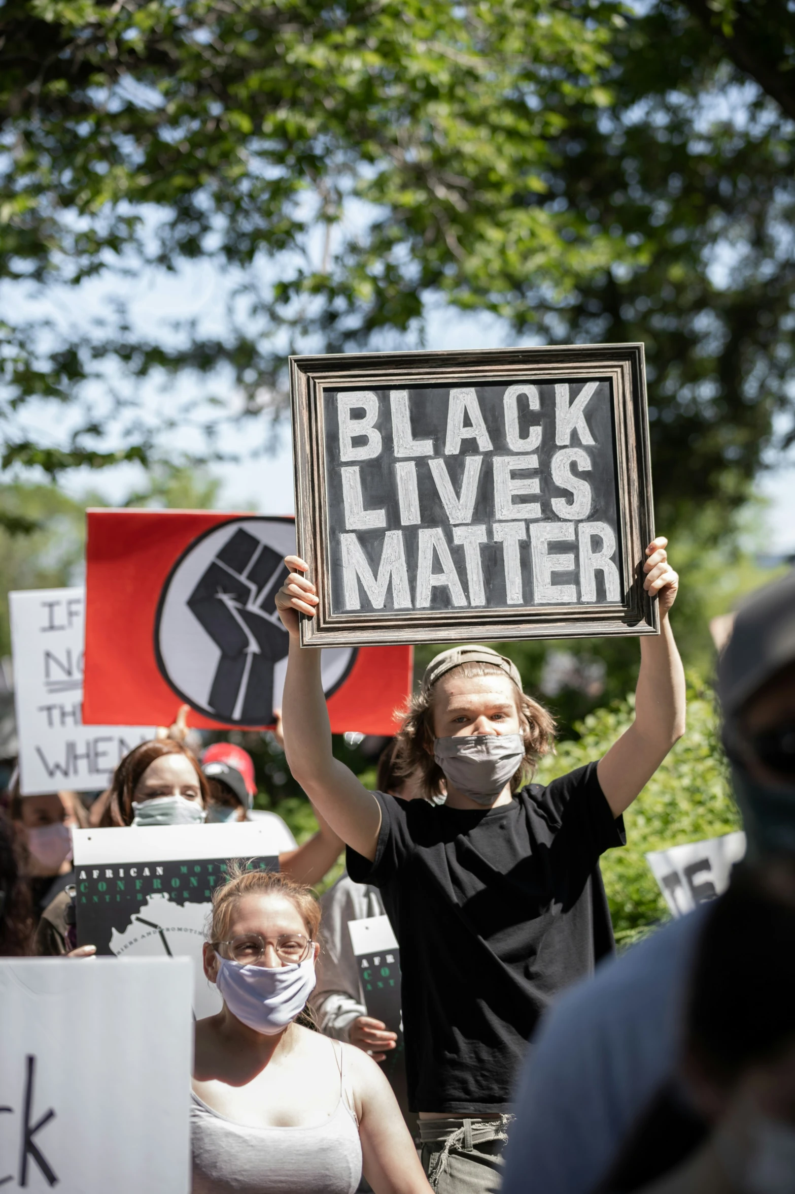 a group of people holding black lives matter signs