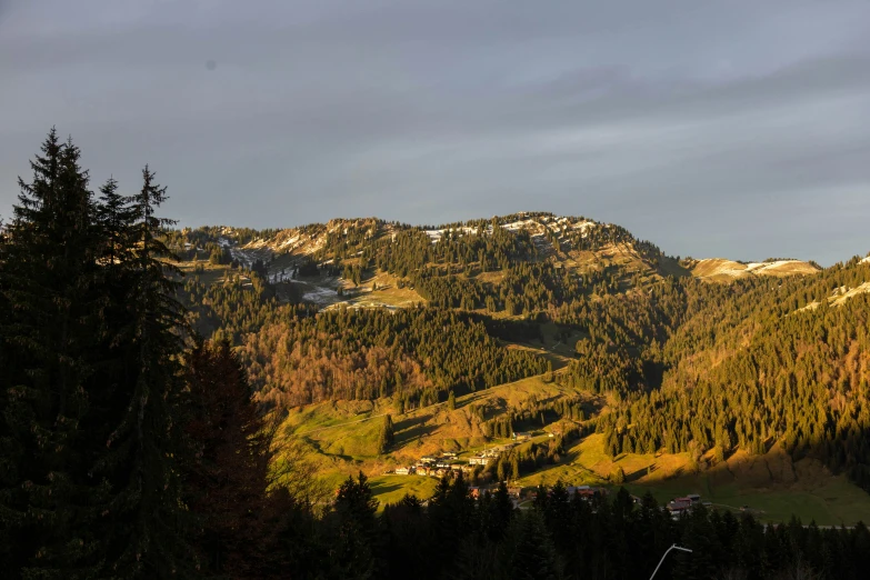 a mountain is shown with a patch of green in the sun