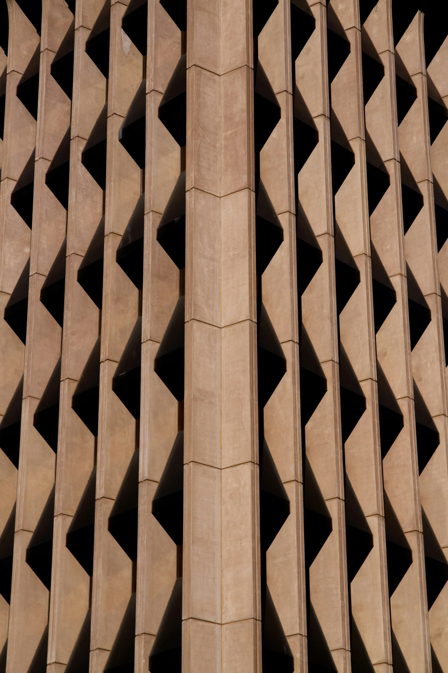 a very tall and unique structure with intricate patterns on the facade