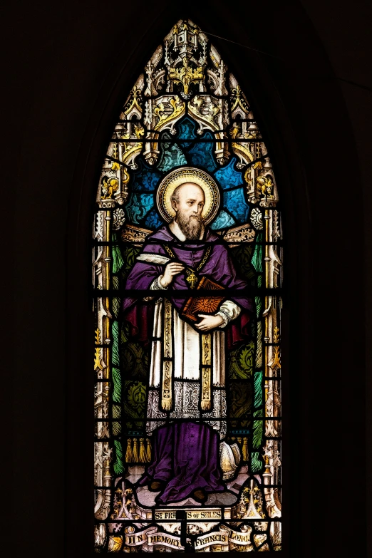 a large stain glass window with a religious person on it