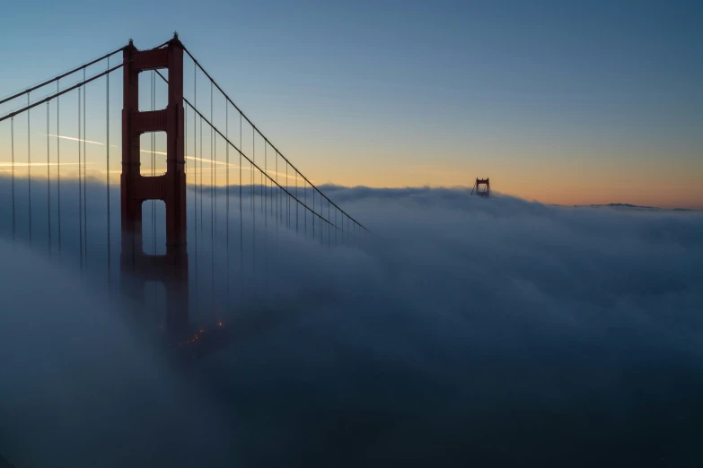 view of golden gate from the top of the suspension bridge in fog