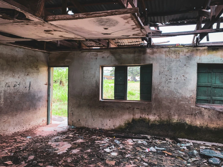 an old house that has windows broken in some sort of building