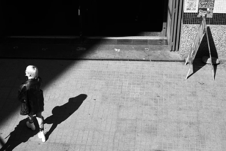 a girl walking down the sidewalk while wearing a fake hair