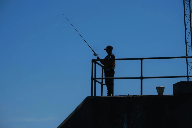 a man fishing from a balcony of an apartment building