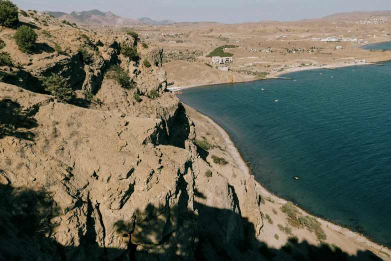 a river in the mountains next to a rocky coastline