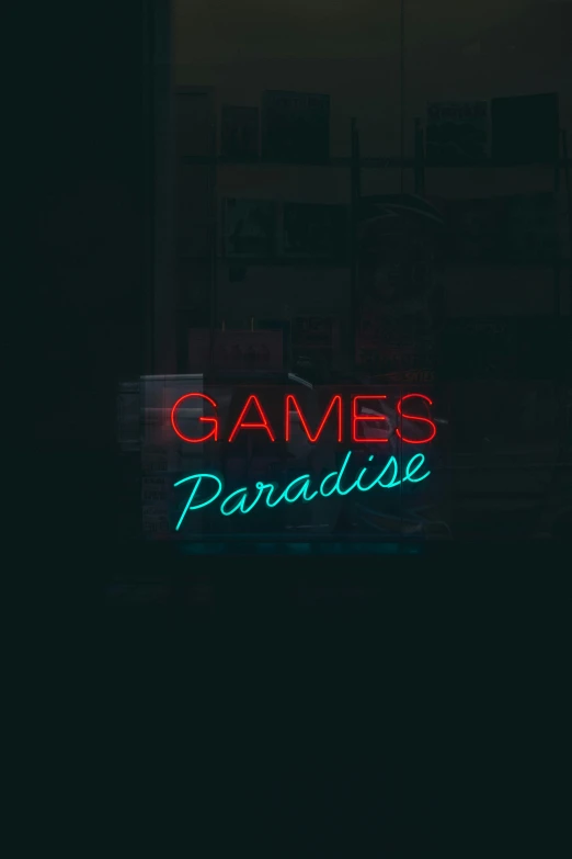 neon game's paradise sign displayed on a window