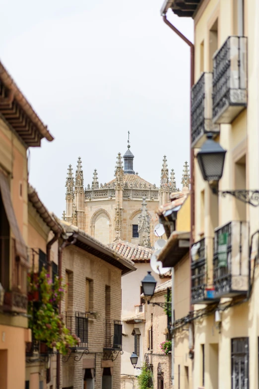 an alley with tall buildings is shown in this view