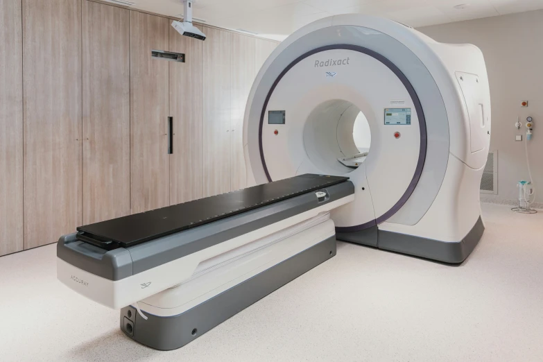 a mri room with several doors and shelves in the background