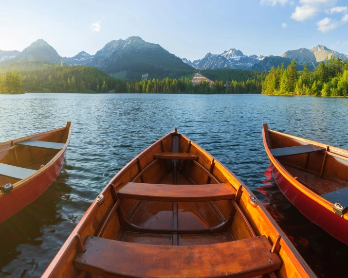 two long canoes, one in a row and the other out on the water