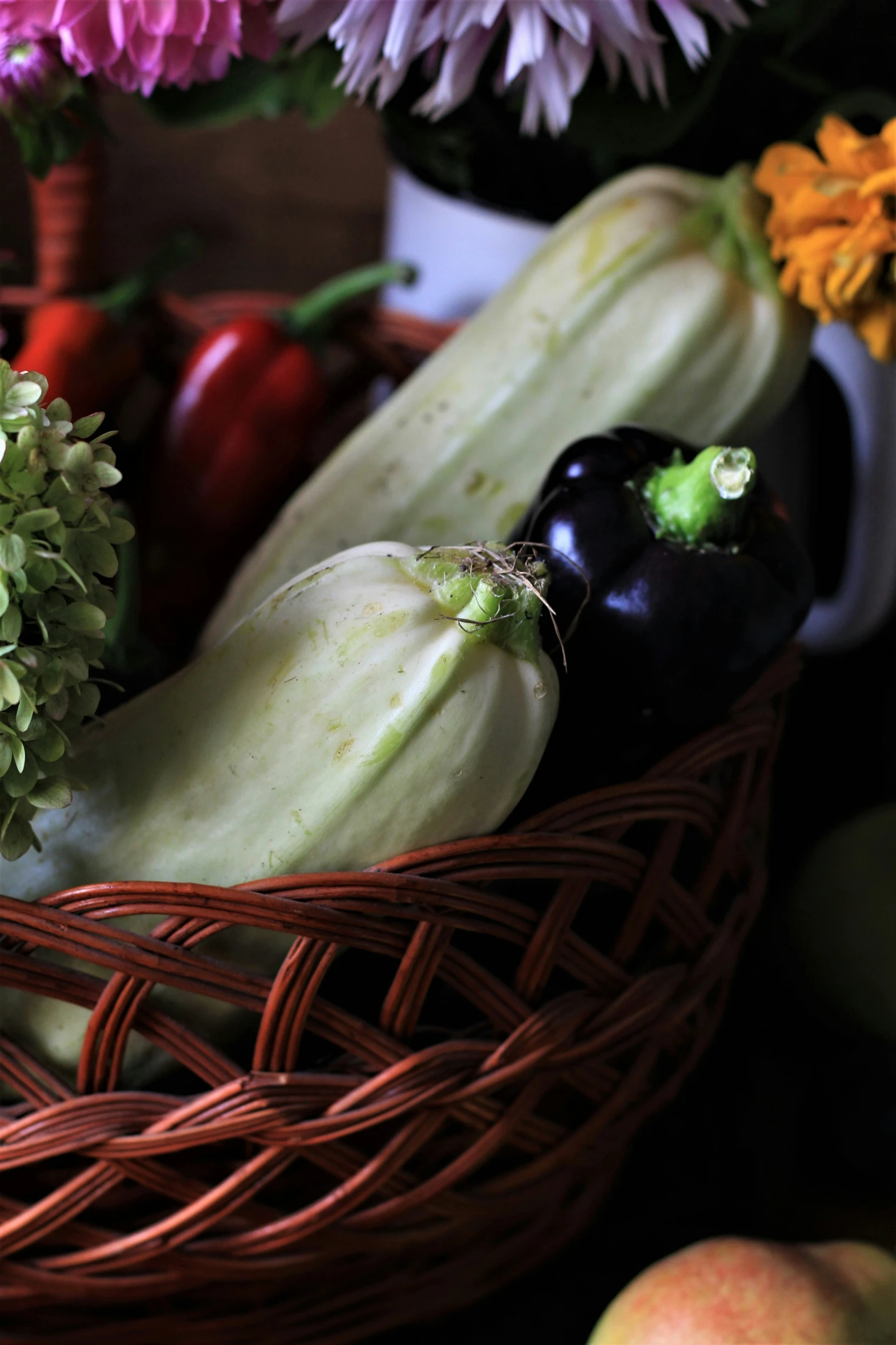 a wicker basket full of different types of fruit and vegetables