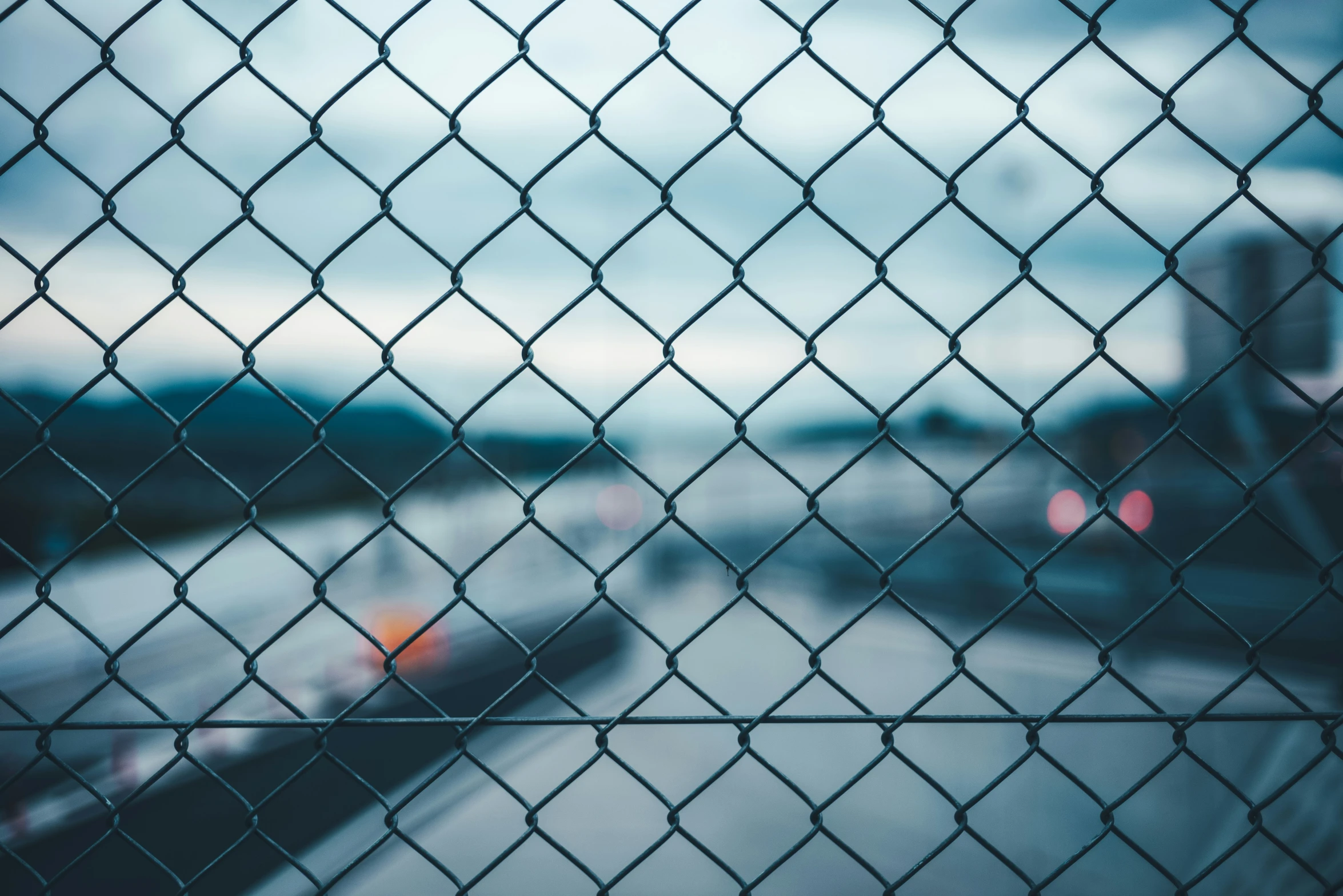 a chain link fence looking out over a street