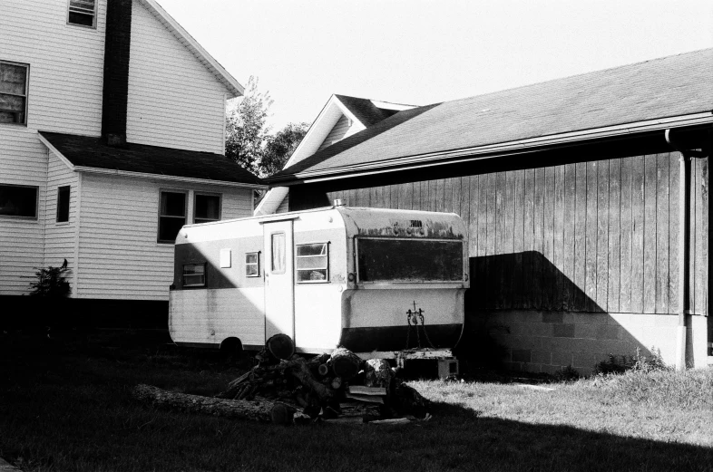 a building with a car outside in the grass