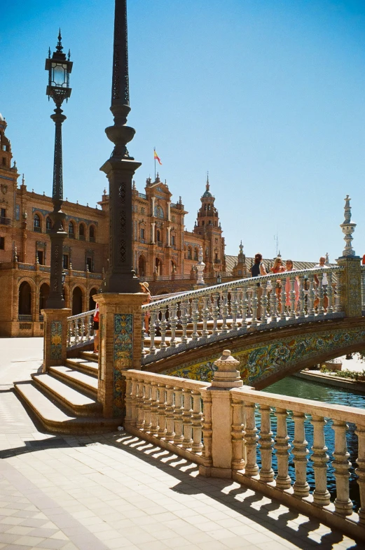 people on steps near a fountain and building