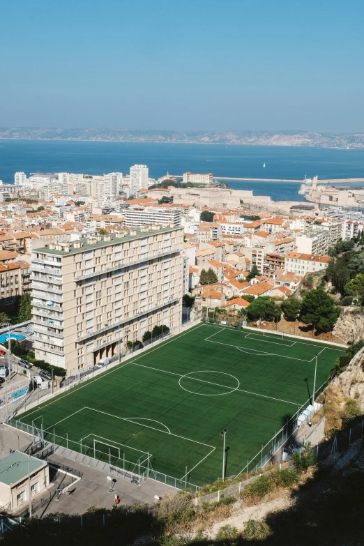 an aerial view of a city and a soccer field