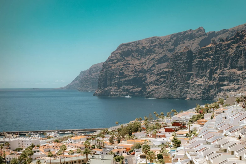 there is a mountain in the background and water in the foreground