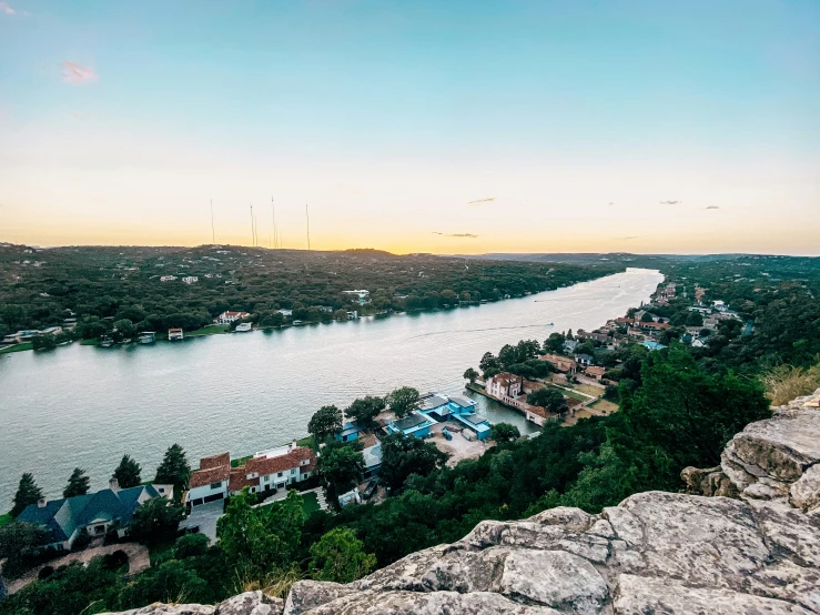 an aerial view over a river and a town with buildings