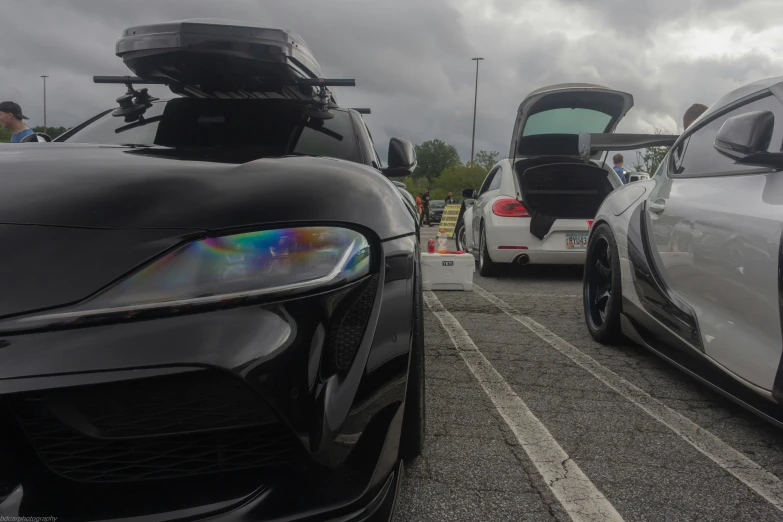 two white and black cars on road under cloudy skies