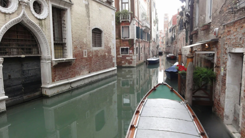 a boat floats in an empty venice canal