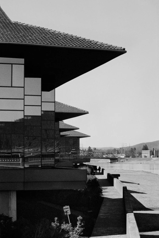 the black and white pograph shows the ocean from outside of the building