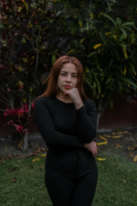 a woman posing with her chin on her hand