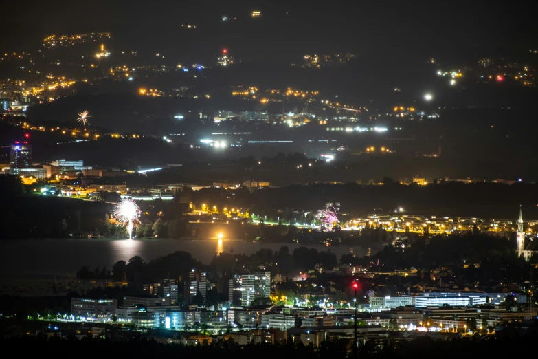 view of the mountains at night with lights in the city lights