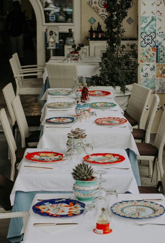 a long dining table set with place settings for six