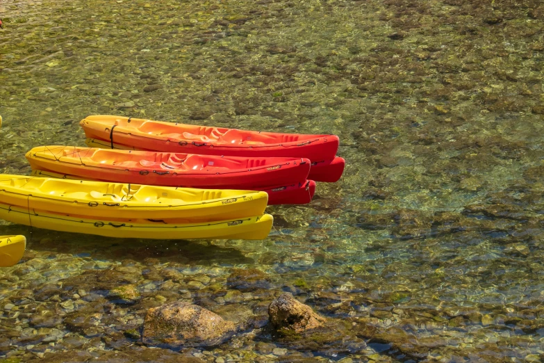 several kayaks sitting side by side on the ocean floor