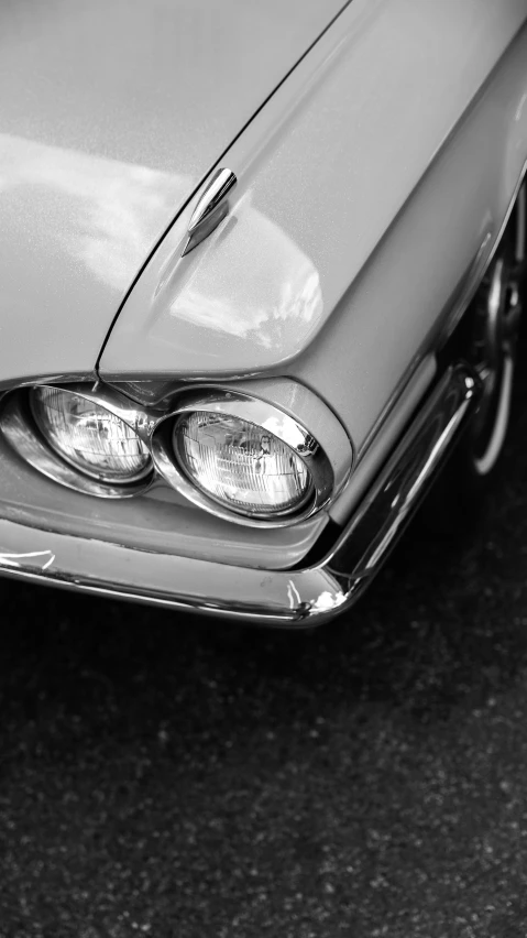 a black and white po of the headlights on an old car