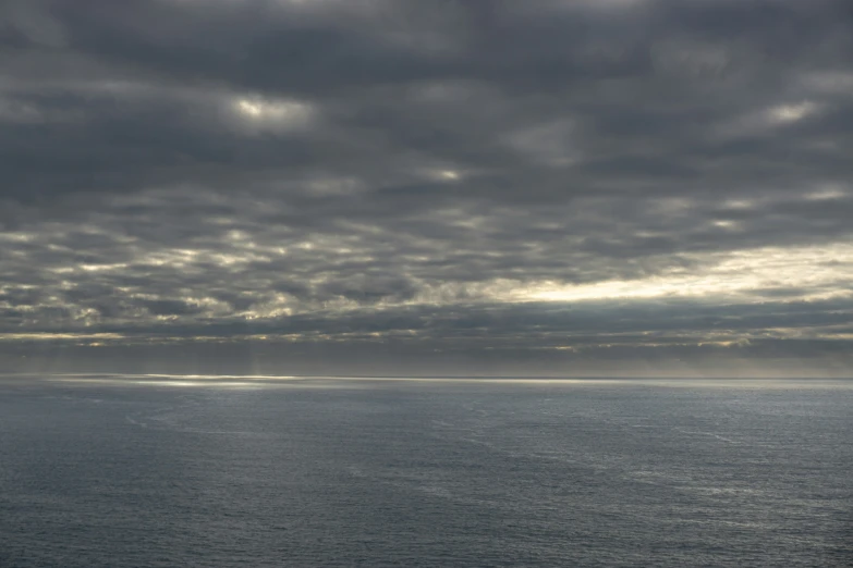 a cloudy day at an ocean with blue water