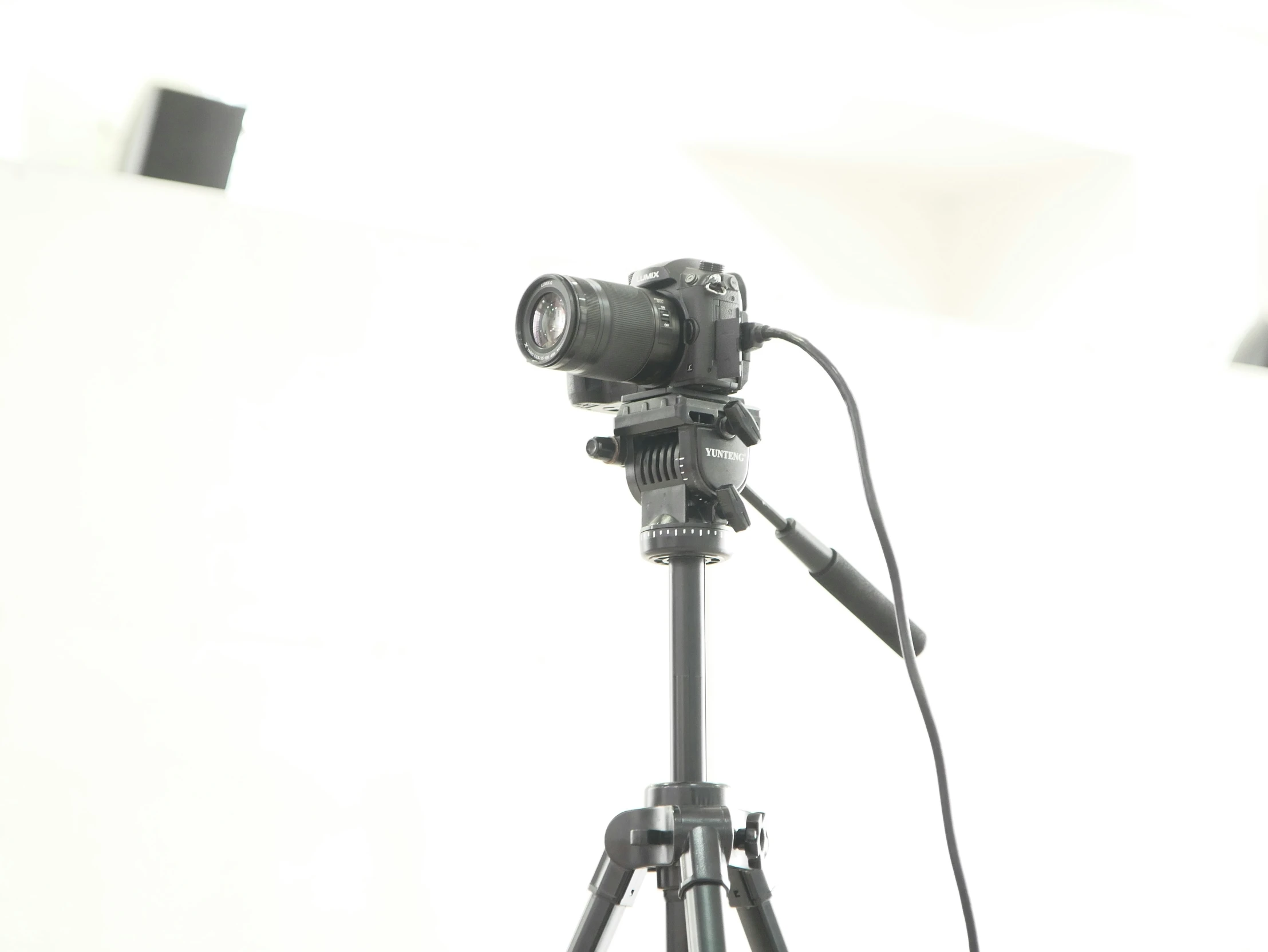 a tripod sitting with a camera in front of it