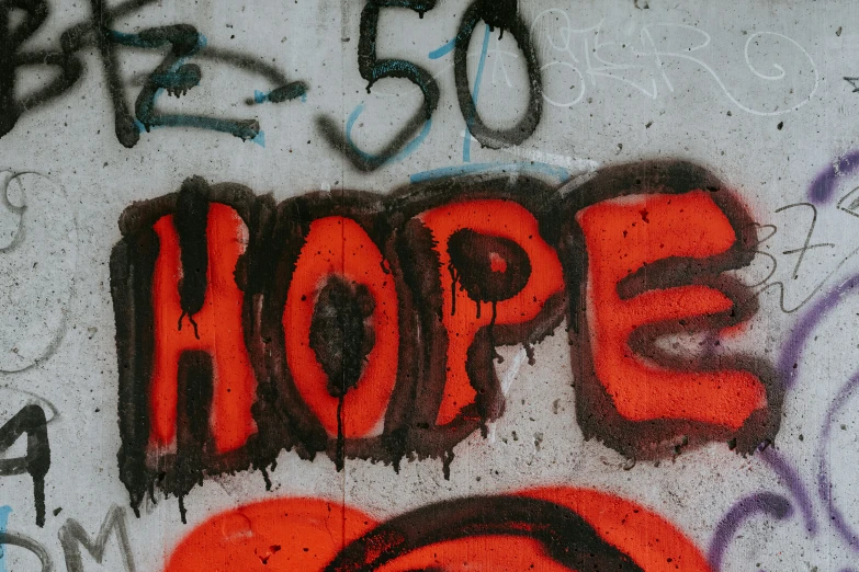 graffiti on the side of a wall with the word hope written above